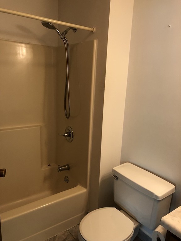 11 R Gamache Road, Unit 11R Derry, NH 03038 - Photo 11 of 20 a white toilet and shower sitting next to a bathroom sink