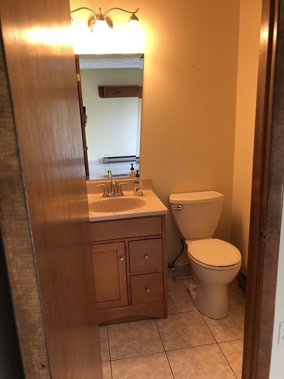 11 R Gamache Road, Unit 11R Derry, NH 03038 - Photo 12 of 20 a bathroom with a toilet sink and mirror