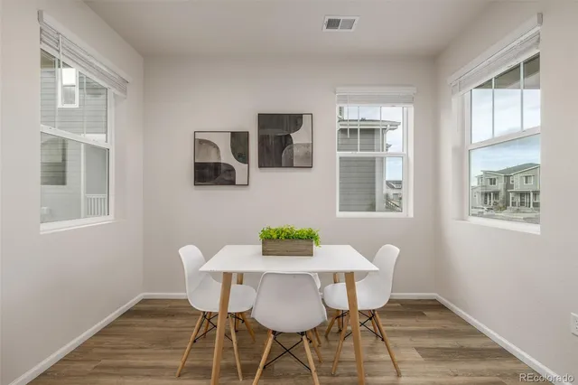 a view of a dining room with furniture window and wooden floor