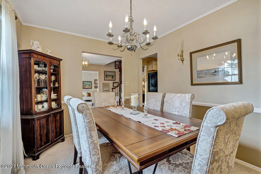 24 Limerick Place Hazlet, NJ 07730 - Photo 11 of 36 a view of a dining room with furniture a chandelier and wooden floor