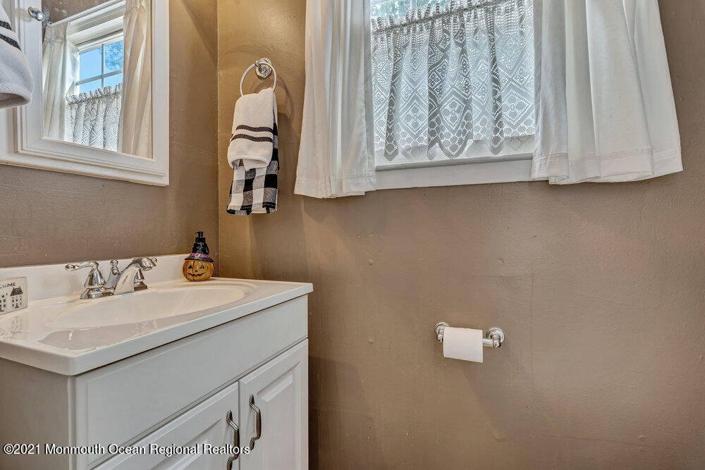 24 Limerick Place Hazlet, NJ 07730 - Photo 16 of 36 a bathroom with a sink and a mirror