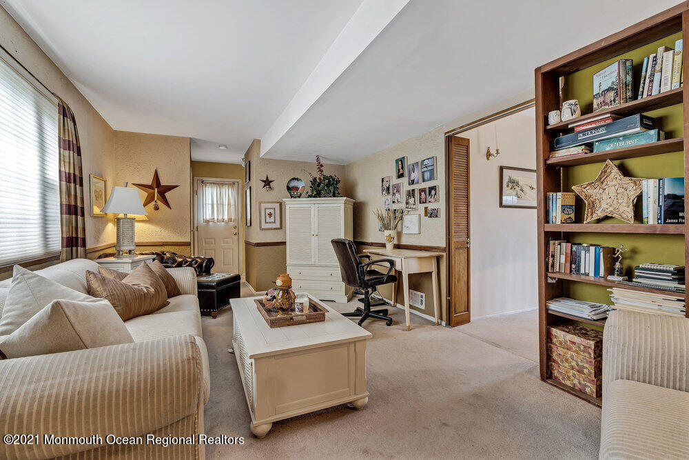 24 Limerick Place Hazlet, NJ 07730 - Photo 19 of 36 a living room with furniture a bookshelf and a window