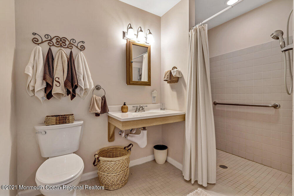 24 Limerick Place Hazlet, NJ 07730 - Photo 23 of 36 a bathroom with a toilet sink and shower