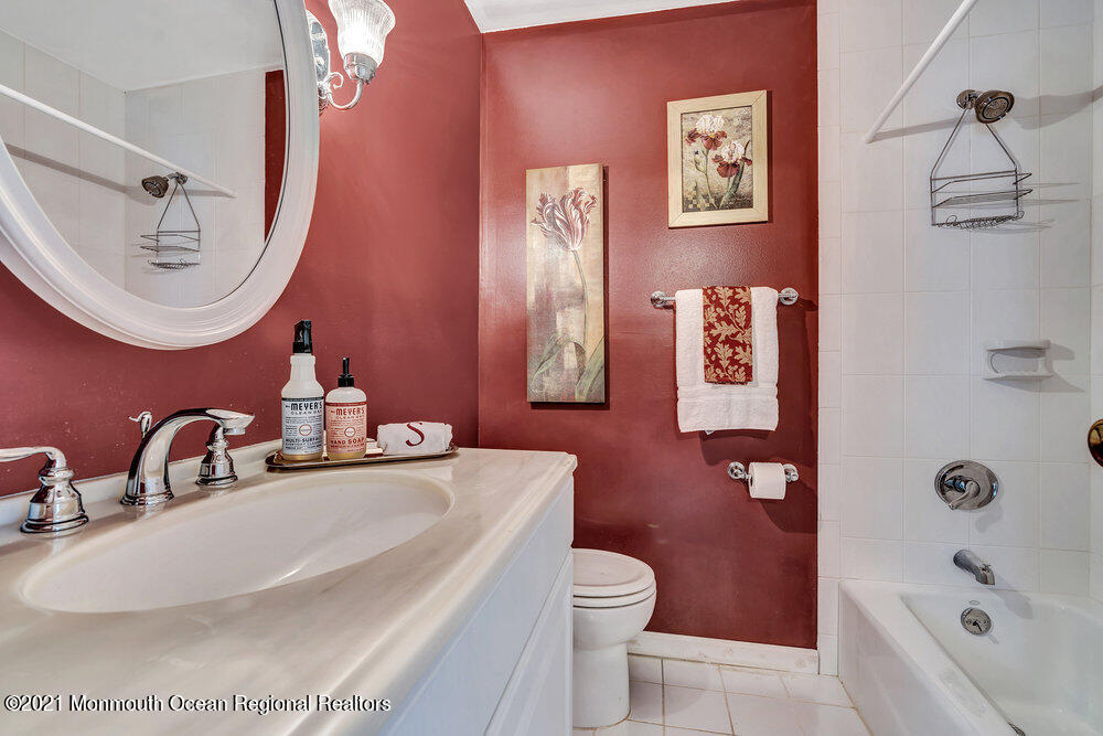 24 Limerick Place Hazlet, NJ 07730 - Photo 26 of 36 a bathroom with a sink a toilet tub and mirror