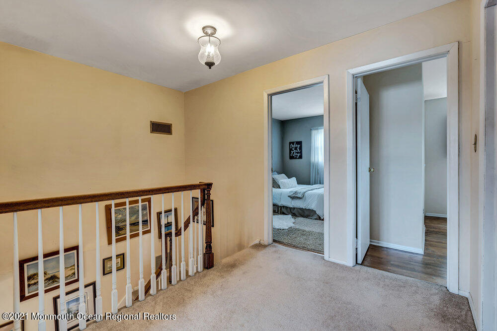 24 Limerick Place Hazlet, NJ 07730 - Photo 27 of 36 a view of a hallway with a livingroom and a chandelier