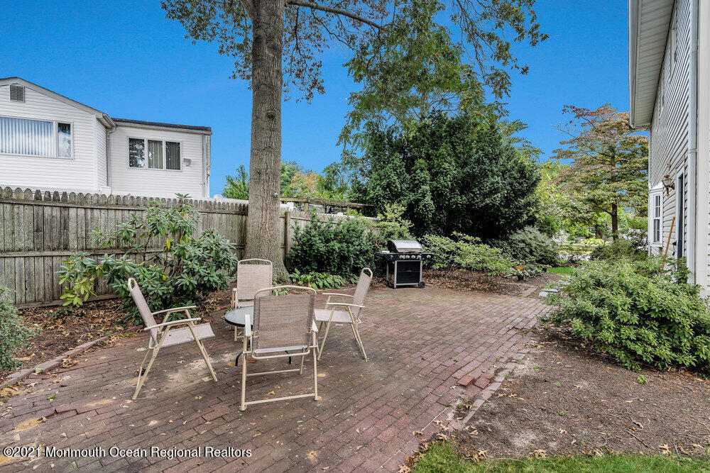 24 Limerick Place Hazlet, NJ 07730 - Photo 32 of 36 a view of a chairs and tables in the backyard