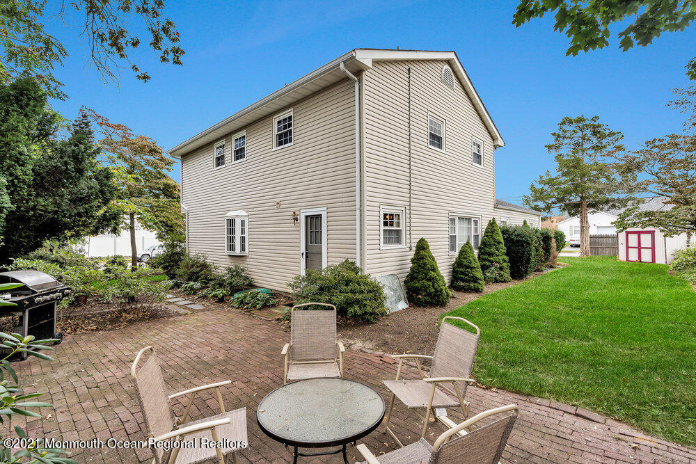 24 Limerick Place Hazlet, NJ 07730 - Photo 33 of 36 a backyard of a house with yard fountain and outdoor seating