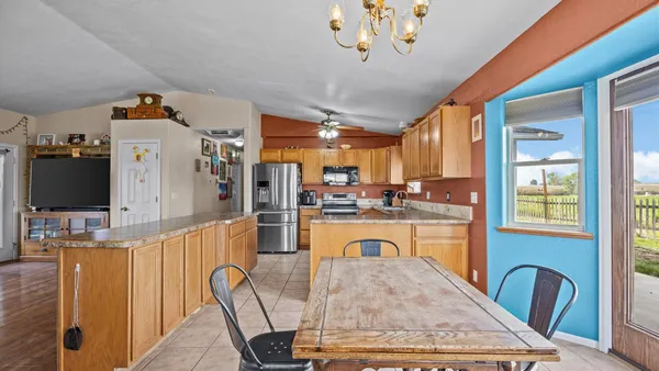 a very nice looking dining room with a large window