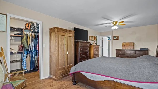 a bedroom with a bed and a chandelier