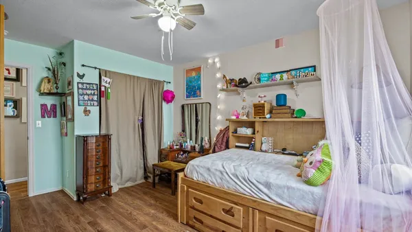 a bedroom with bed and a window