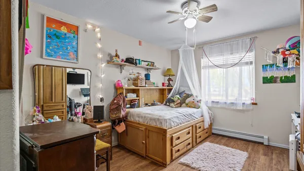a bedroom with bed and a chandelier