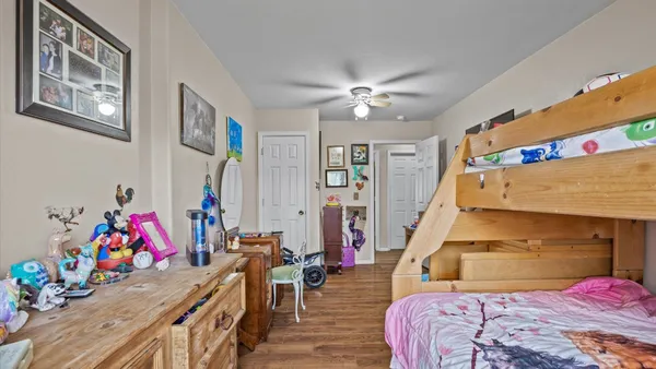 a bedroom with furniture and a wooden floor