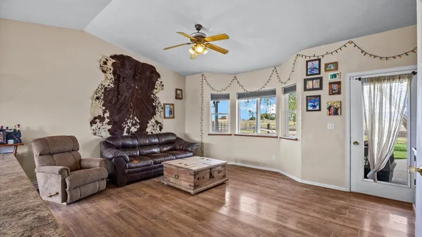 a living room with furniture and wooden floor