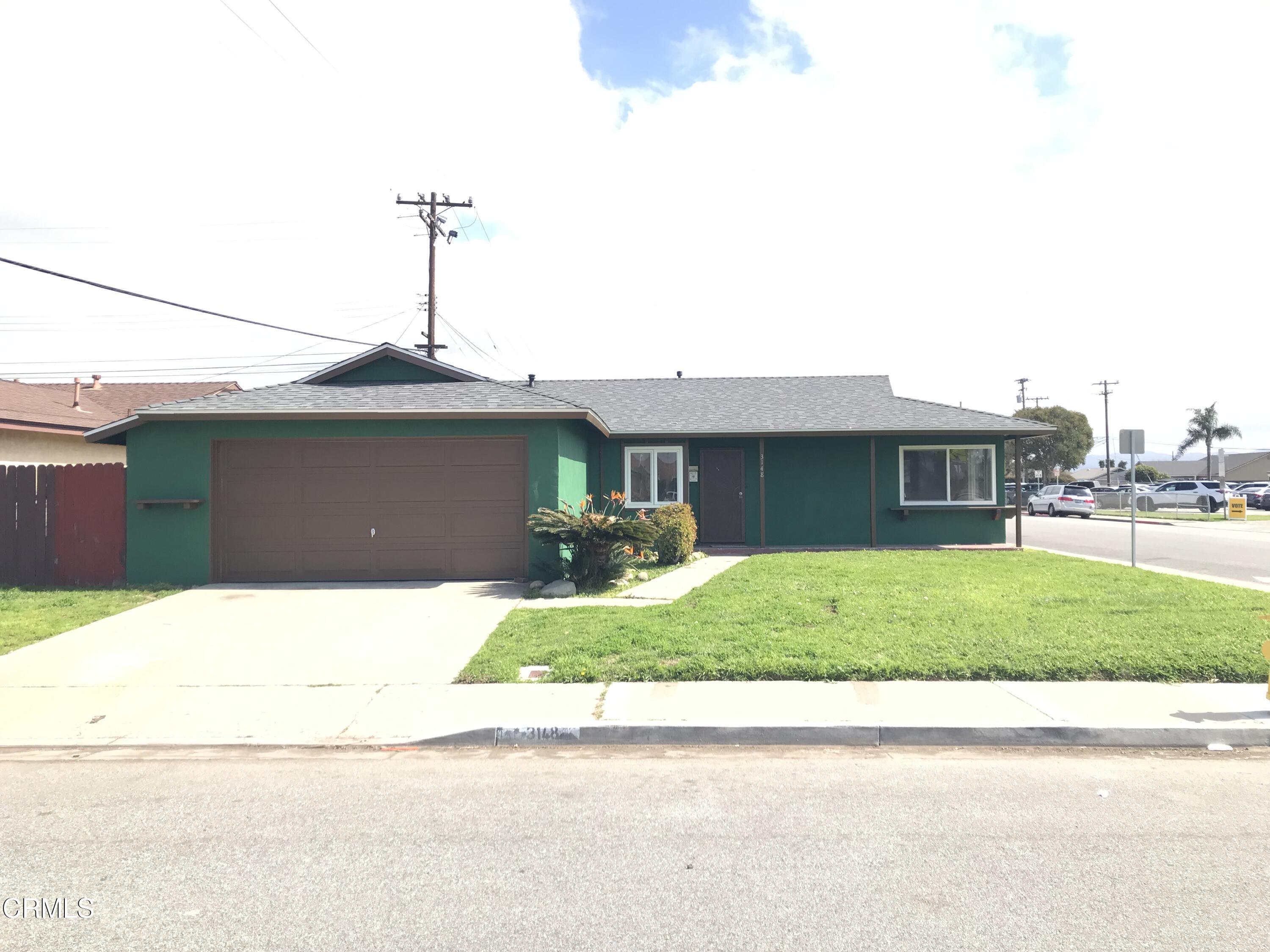 3148 Napa Street Oxnard, CA 93033 - Photo 2 of 15 a front view of a house with a yard and garage