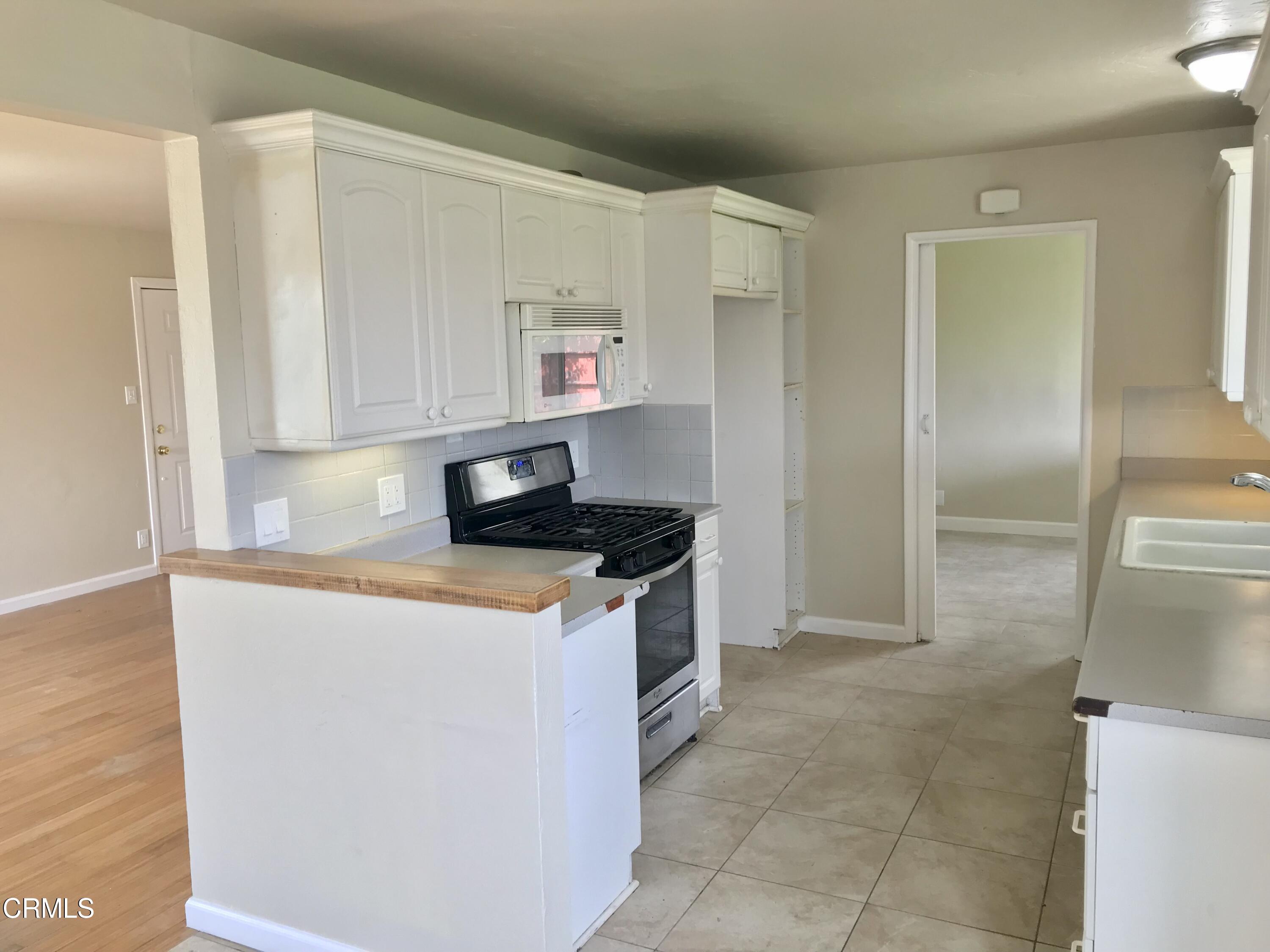 3148 Napa Street Oxnard, CA 93033 - Photo 6 of 15 a kitchen with stainless steel appliances granite countertop a refrigerator and a stove