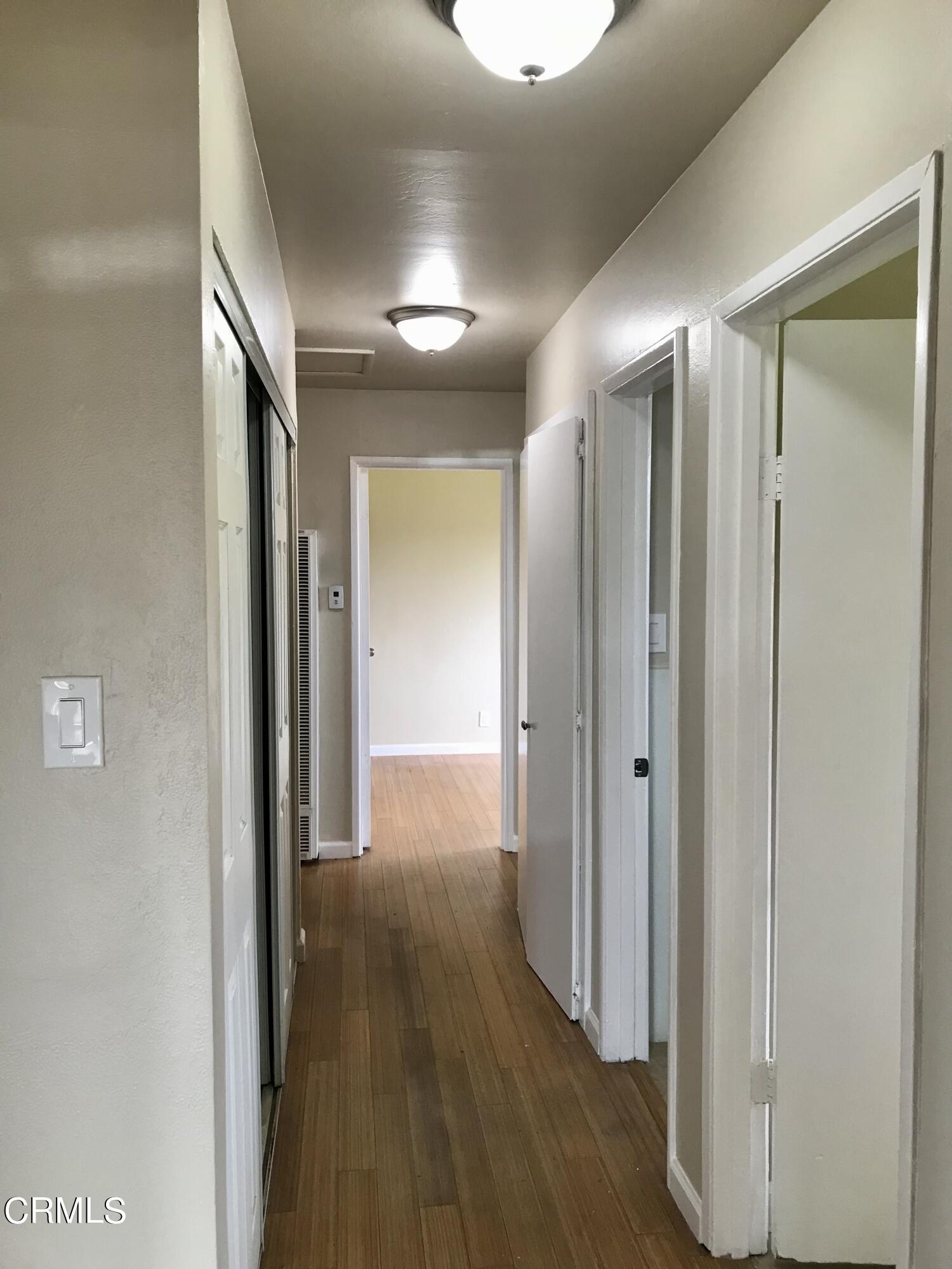 3148 Napa Street Oxnard, CA 93033 - Photo 8 of 15 a view of hallway with wooden floor