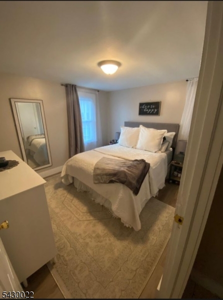 a bedroom with a bed and a mirror