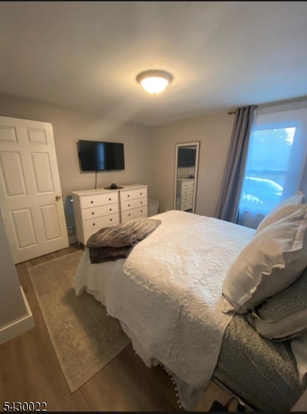 3 Plane Street Stanhope, NJ 07874 - Photo 2 of 25 a bedroom with a bed a flat screen tv and view kitchen
