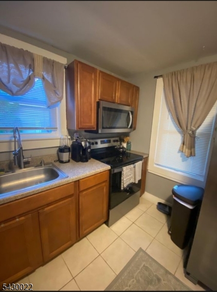3 Plane Street Stanhope, NJ 07874 - Photo 7 of 25 a kitchen with stainless steel appliances a sink cabinets and a window