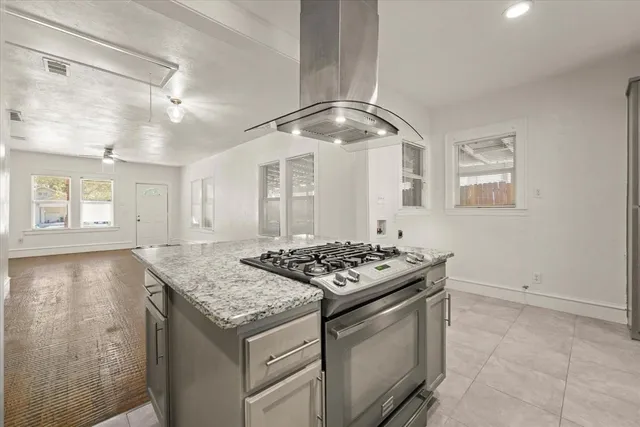 a kitchen with stainless steel appliances granite countertop a stove and a sink