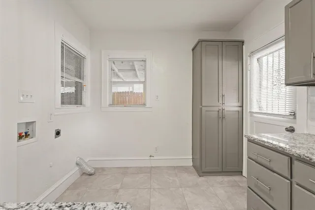a bathroom with a granite countertop sink and mirror with bathtub