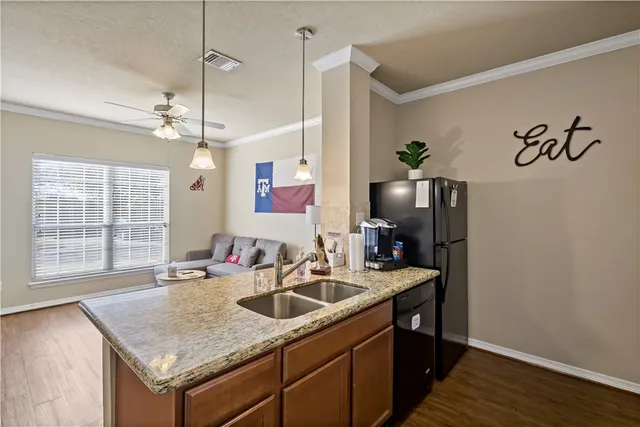 a kitchen with a sink a counter space and a window