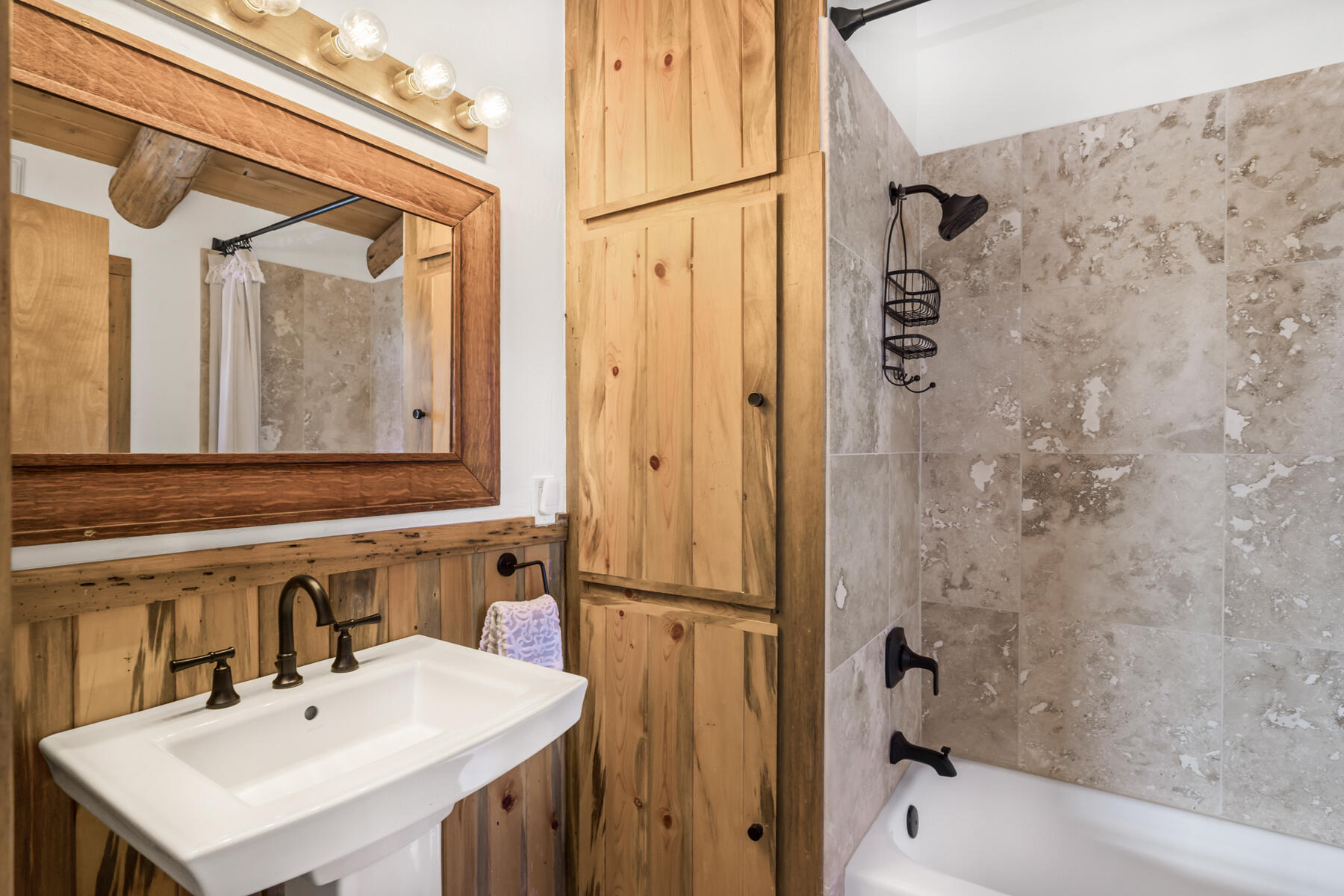 17026 Sharp Drive Bend, OR 97707 - Photo 44 of 72 a bathroom with a sink a mirror and a bathtub