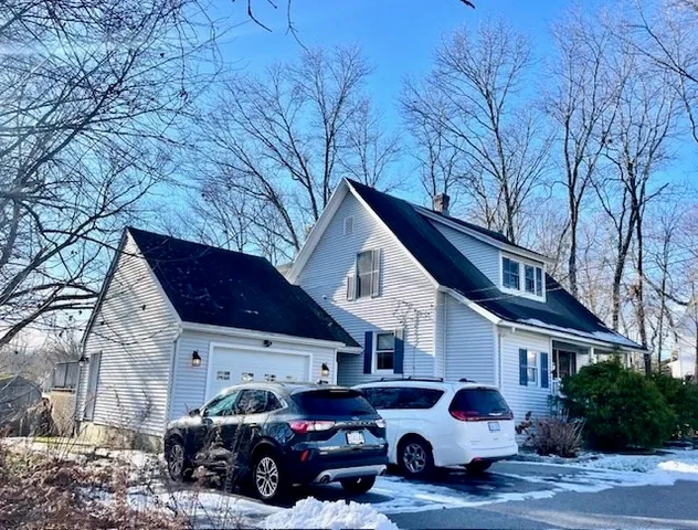 a car parked in front of white house