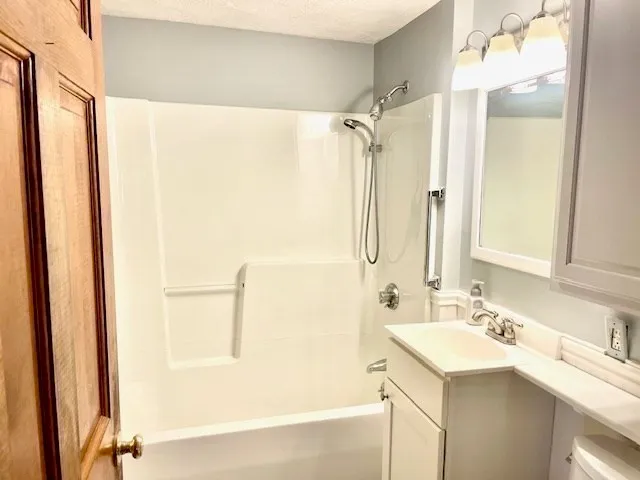 a bathroom with a double vanity sink mirror and shower
