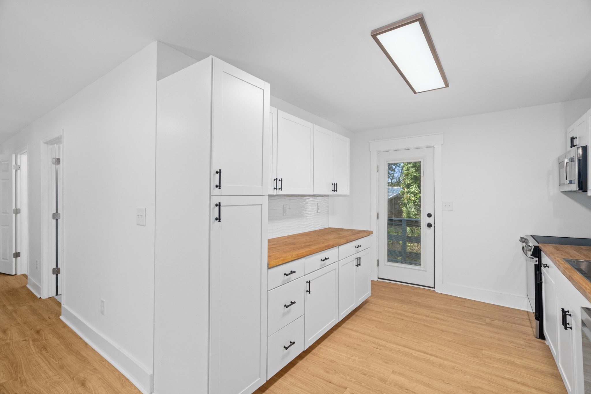 418 Jones Street Pulaski, TN 38478 - Photo 4 of 18 a large white kitchen with a sink and dishwasher