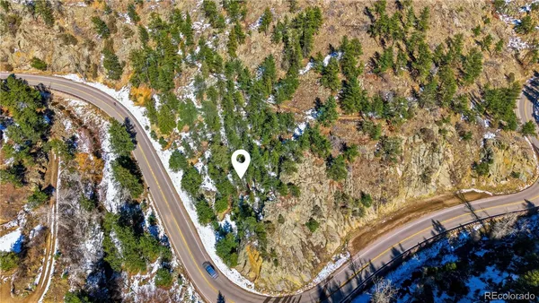 a view of a large building with mountains in the background