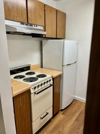 a kitchen with a sink a stove and a refrigerator