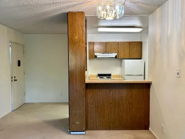 a kitchen with a sink and wooden cabinets