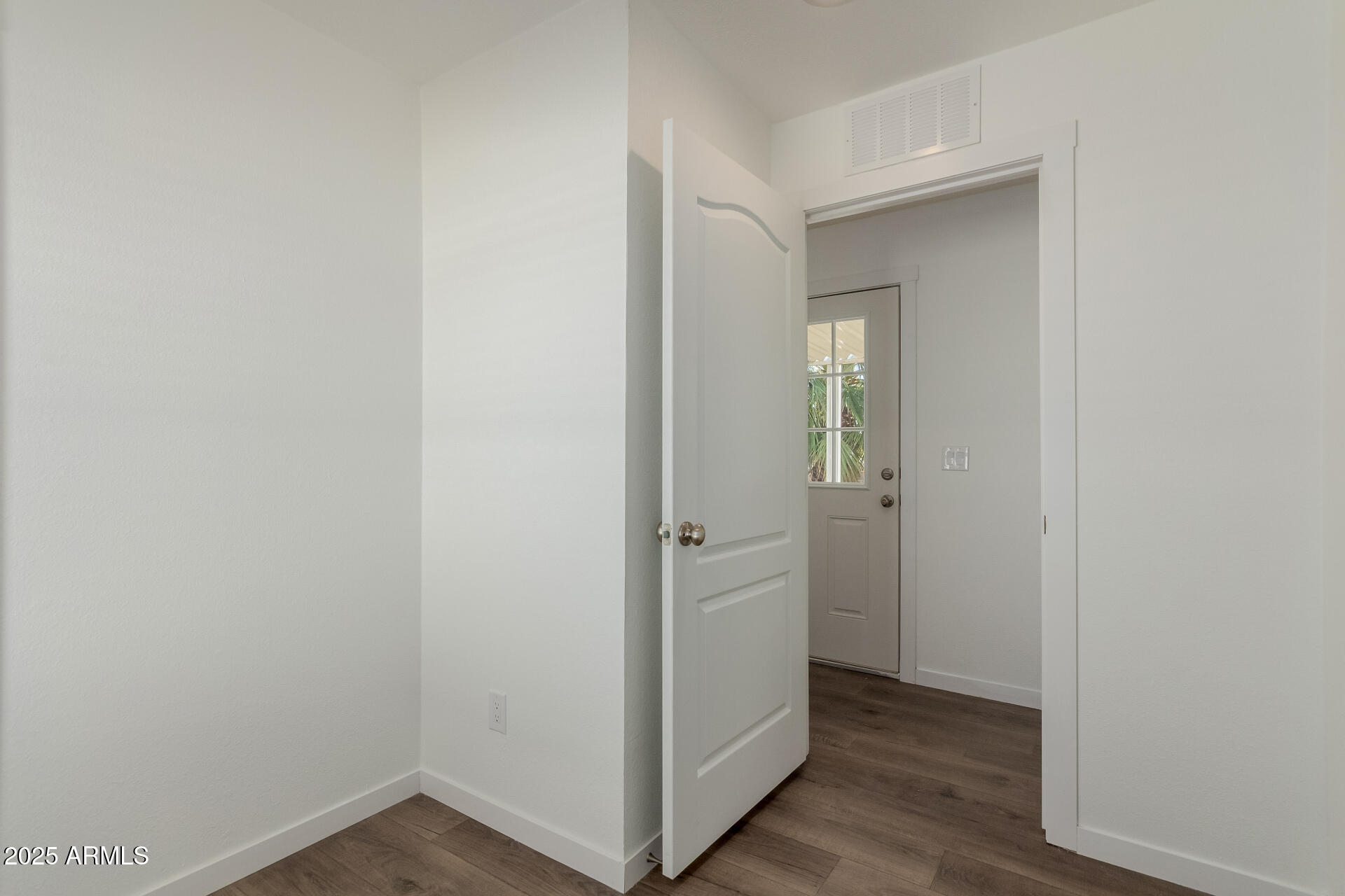 5201 West Camelback Road, Unit A257 Phoenix, AZ 85031 - Photo 9 of 13 a view of an empty room with wooden floor