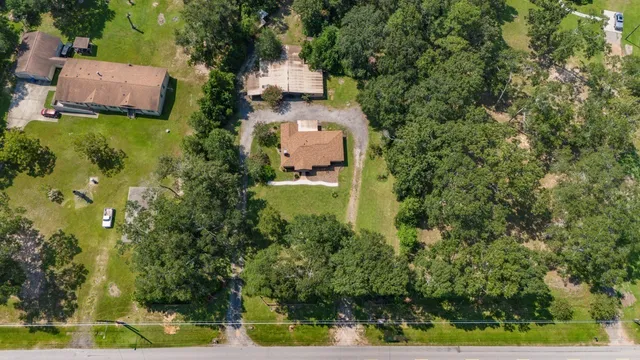 an aerial view of a house with a yard basket ball court and outdoor seating