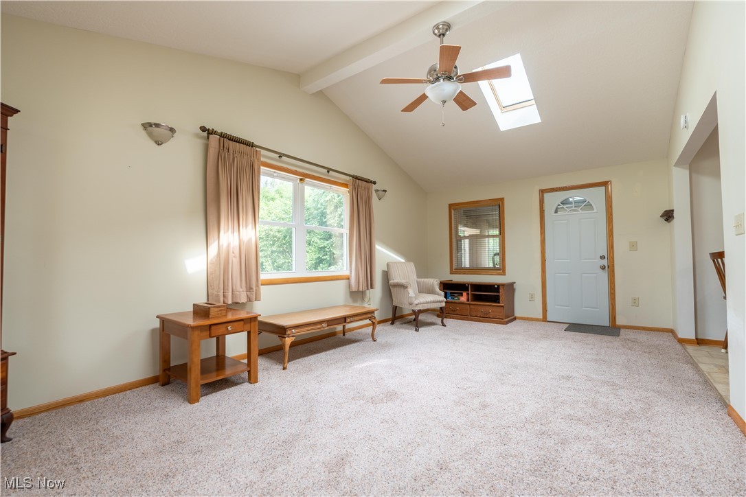 1766 Far View Road Akron, OH 44312 - Photo 12 of 33 Family room featuring carpet, skylights, a ceiling fan, and high vaulted ceiling