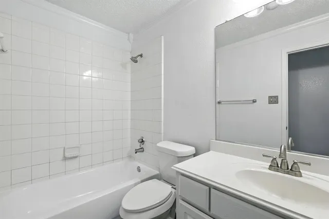 a bathroom with a sink a toilet and bathtub