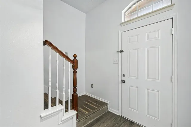 a view of front door with wooden floor