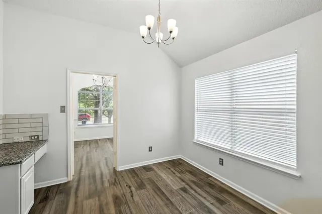 a view of a room with wooden floor and windows