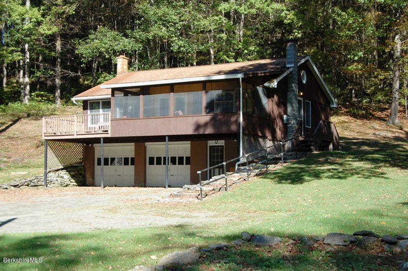 a view of a house with yard and sitting area