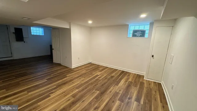 a view of a room with wooden floor and bathroom