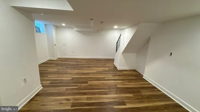 a view of a room with wooden floor