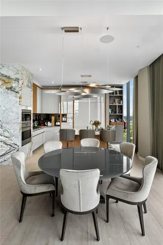 a living room with furniture kitchen view and a table