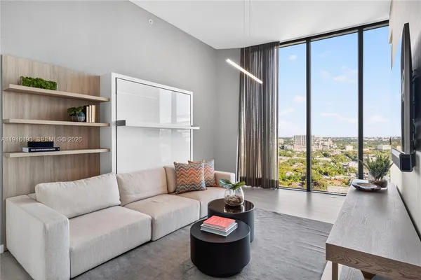a living room with furniture and a large window