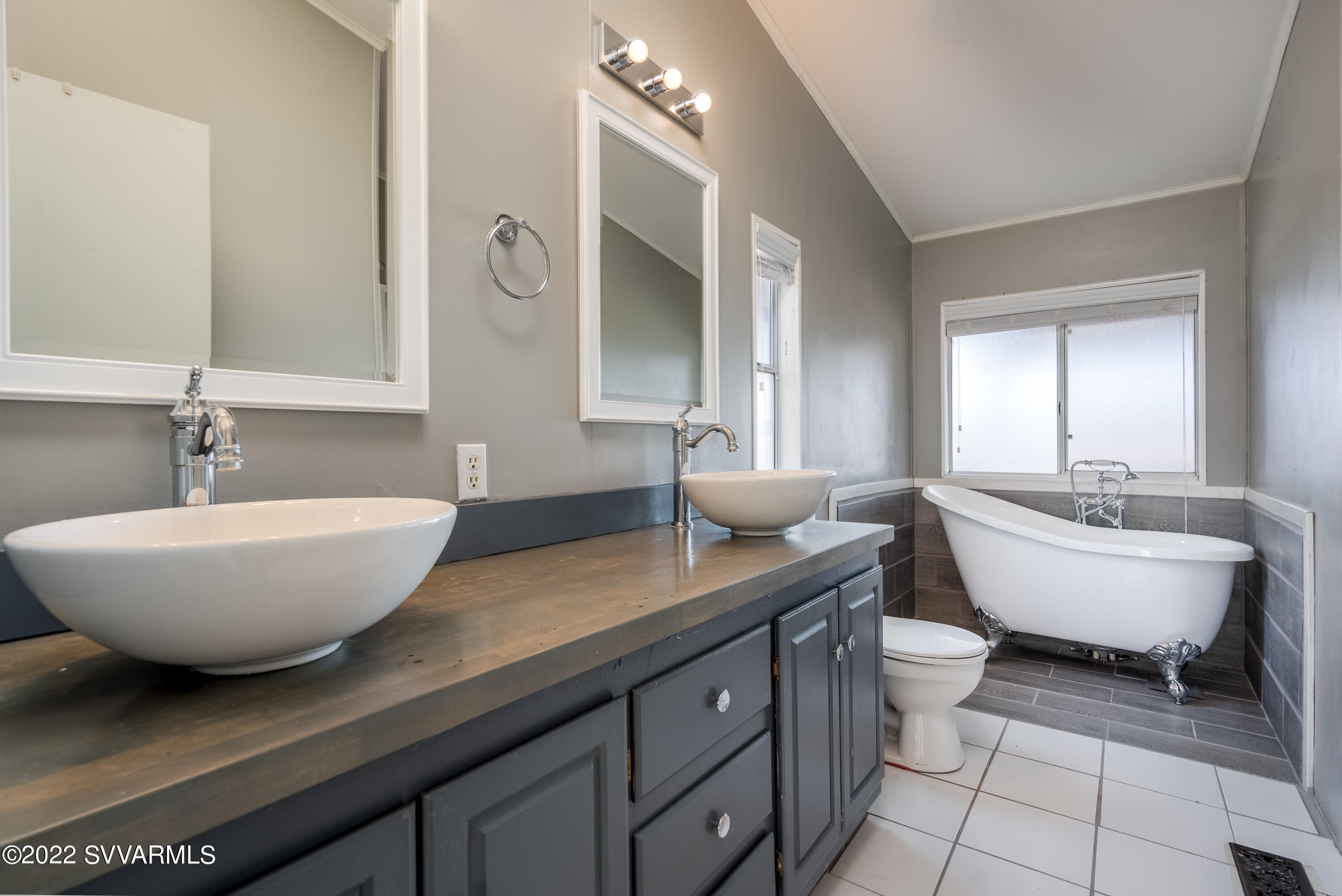 2210 East Kimberleys Way Rimrock, AZ 86335 - Photo 15 of 35 a spacious bathroom with a double vanity sink a mirror and a bathtub