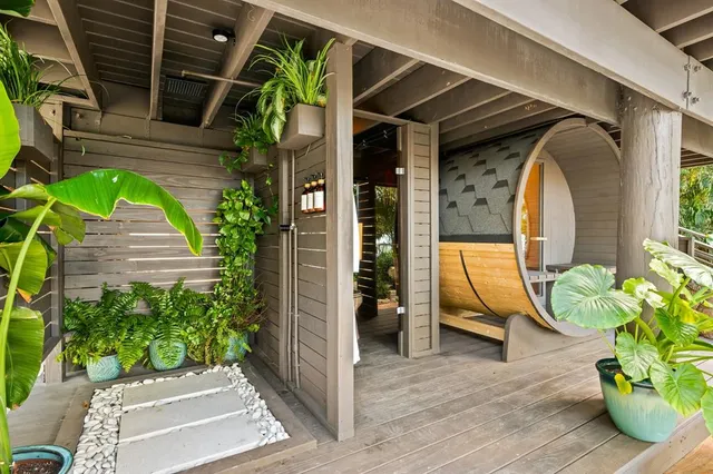 a roof deck with table and chairs under an umbrella