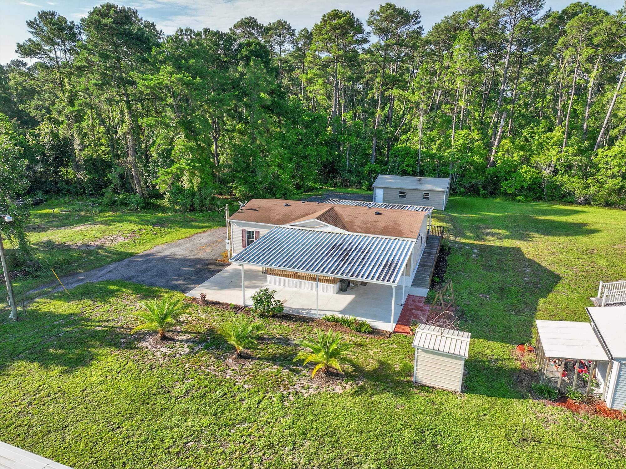101 Trout Trail Crescent City, FL 32112 - Photo 26 of 45 a view of a house with a yard and sitting area