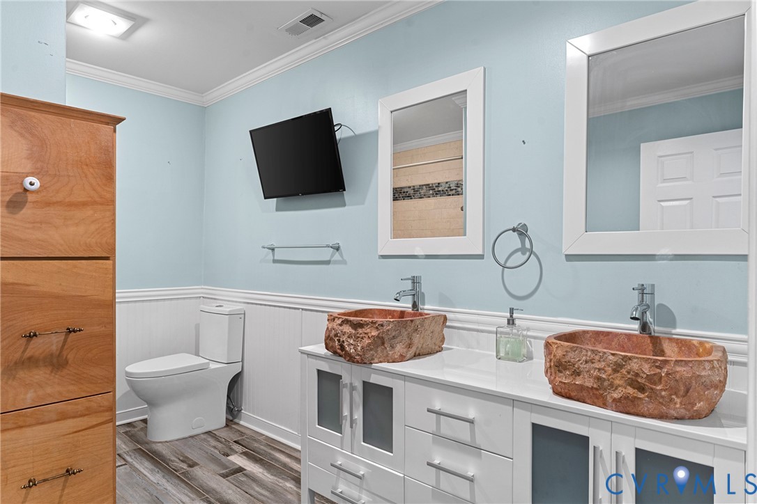 8059 Varina Road Henrico, VA 23231 - Photo 15 of 45 a bathroom with a granite countertop toilet sink and mirror