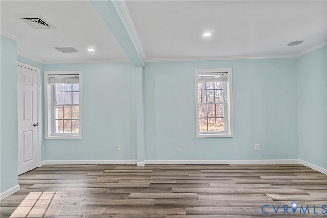 8059 Varina Road Henrico, VA 23231 - Photo 17 of 45 a view of an empty room with wooden floor and a window