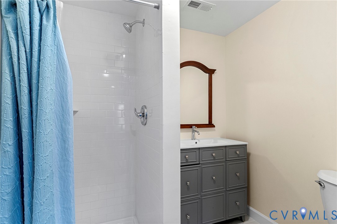 8059 Varina Road Henrico, VA 23231 - Photo 19 of 45 a bathroom with a sink a toilet and mirror